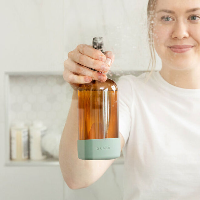 person spraying Glass & Mirror Cleaner grapefruit & palmarosa