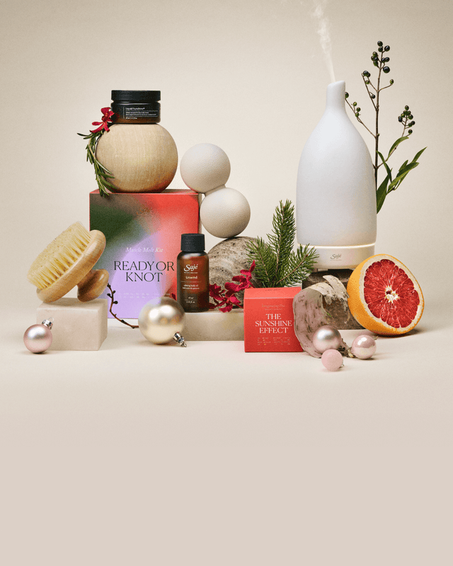 A collection of limited-edition Holiday products arranged among festive decor.